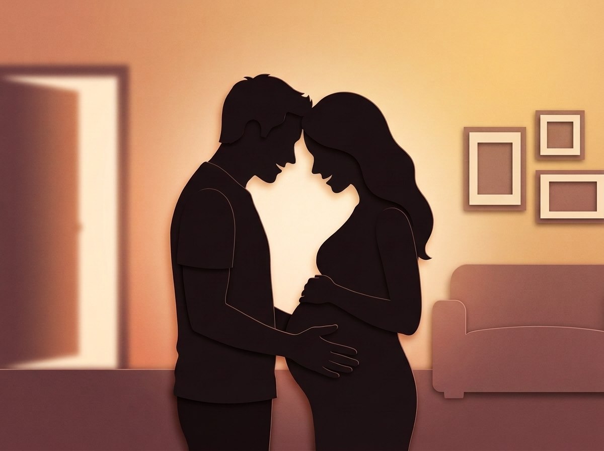 Papercut silhouette of two expectant parents standing forehead to forehead in a warm lounge room